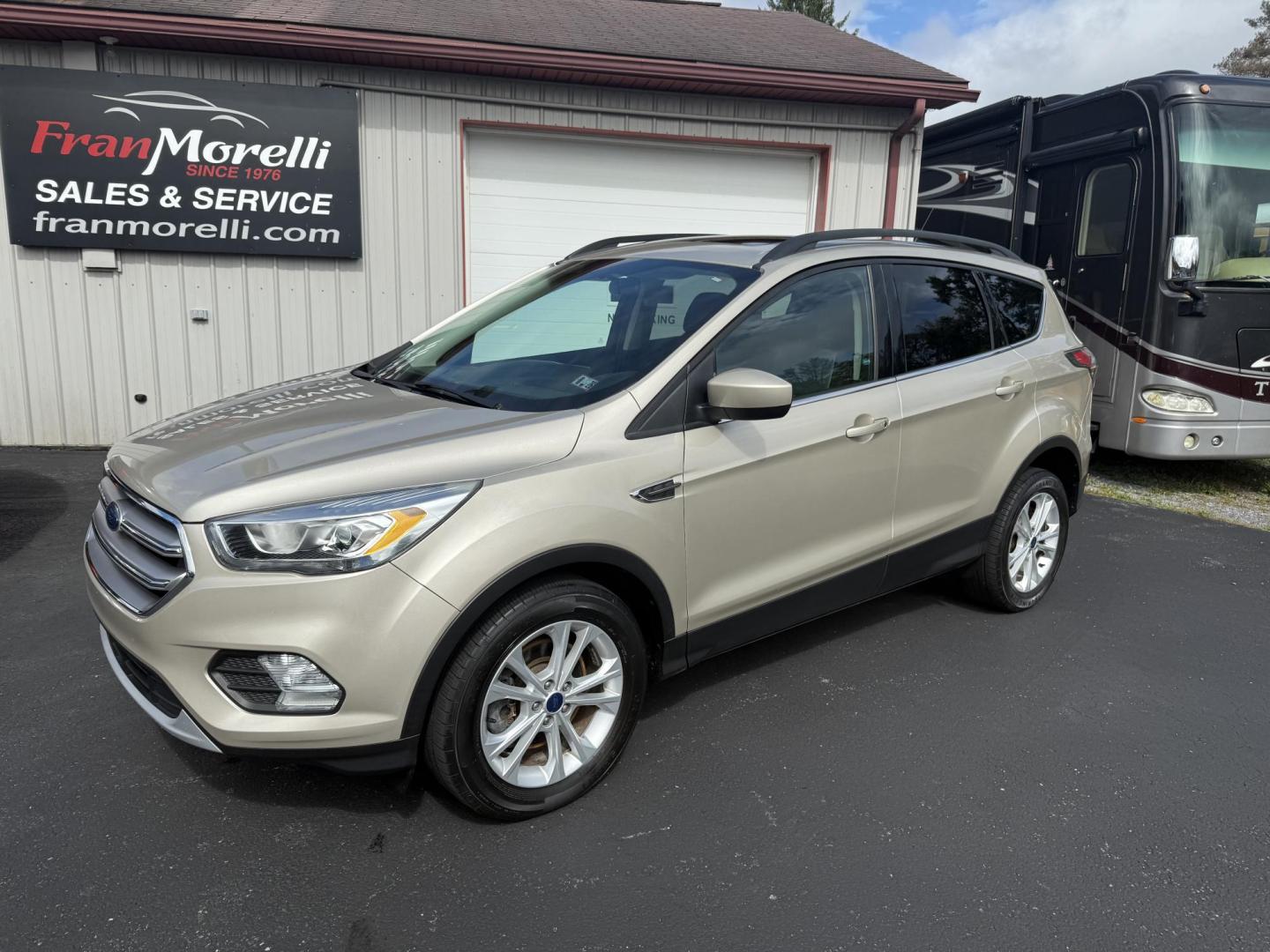 2017 Beige Ford Escape SE 4WD (1FMCU9GD2HU) with an 1.5L L4 DOHC 16V engine, 6A transmission, located at 8464 Route 219, Brockway, PA, 15824, (814) 265-1330, 41.226871, -78.780518 - One sharp pre owned Ford Escape SE 4-wheel drive with air condition, power windows and locks, power seat, pano-roof, factory alloys, and only 53,000 miles. This Ford is serviced, Pa-inspected. Stop in or call one of the Morelli brothers today on this nice suv. - Photo#0